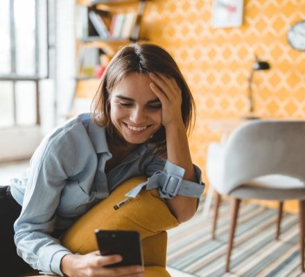 woman smiling at phone